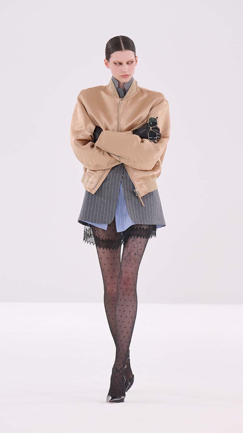 Laagjeslook van Tom Ford met krijtstreepblazer, kort jack, overhemd en kanten jurk. Photo courtesy of Tom Ford