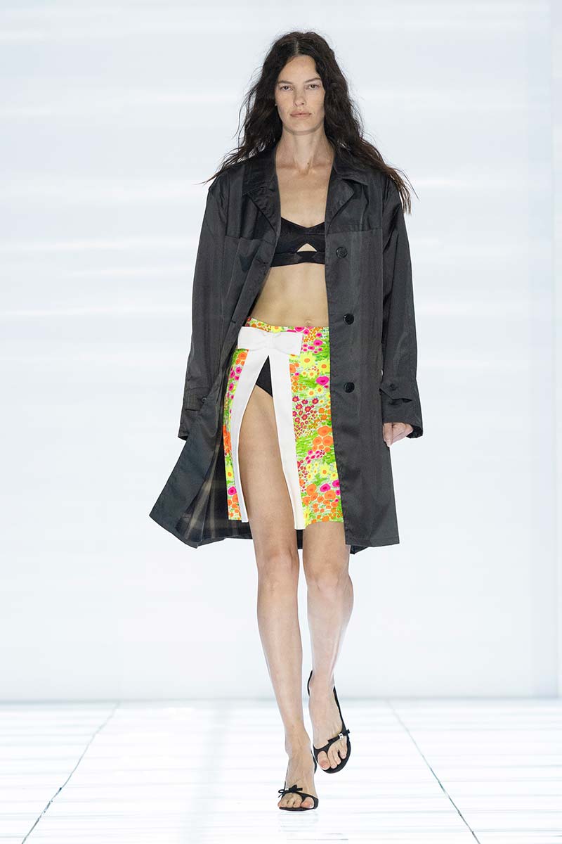 Rok met retro fantasie en halflange zomerjas. Photo courtesy of Prada